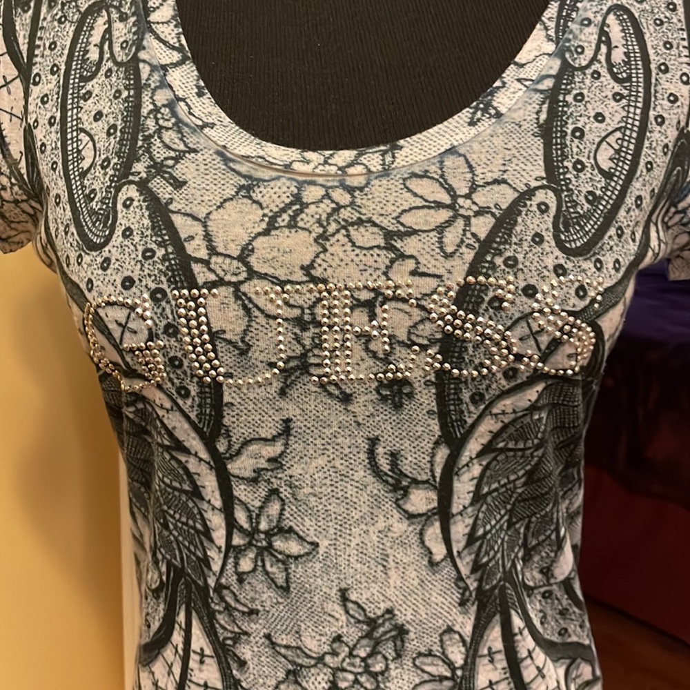 Guess T shirt size XL but runs super small more like a medium